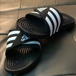 Black and white adidas slides